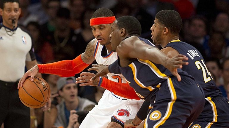 Knicks' Carmelo Anthony is double teamed by the Indiana Pacers'...