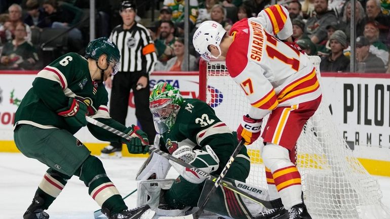 Calgary Flames center Yegor Sharangovich (17) scores a goal past...