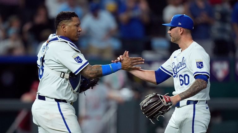 Kansas City Royals catcher Salvador Perez and relief pitcher Lucas...