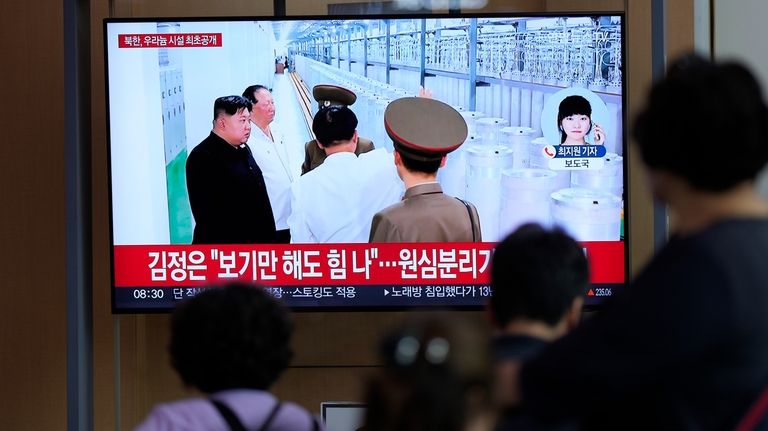 A TV screen shows an image of North Korean leader...