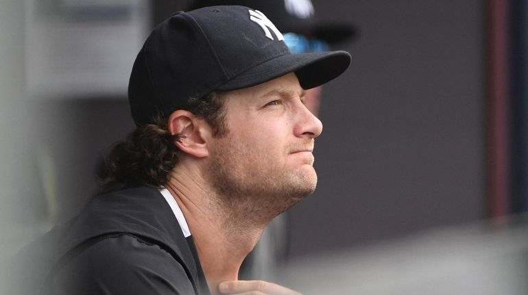 Yankees pitcher Gerrit Cole looks on from the dugout during...