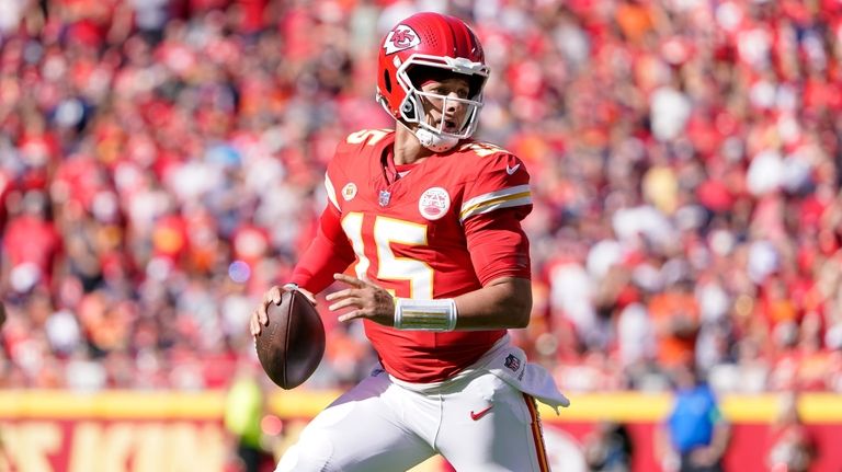 Kansas City Chiefs quarterback Patrick Mahomes runs with the ball...