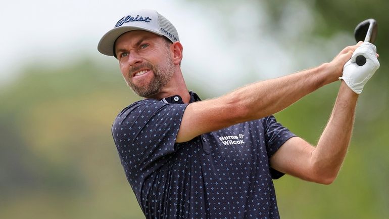 Webb Simpson tees off on the second hole during the...