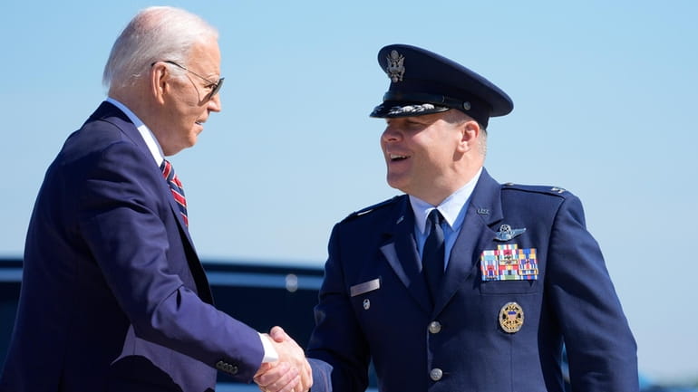 President Joe Biden is greeted by Col. Paul Pawluk, Vice...
