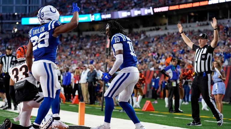 Indianapolis Colts wide receiver Adonai Mitchell (10) celebrates with teammate...