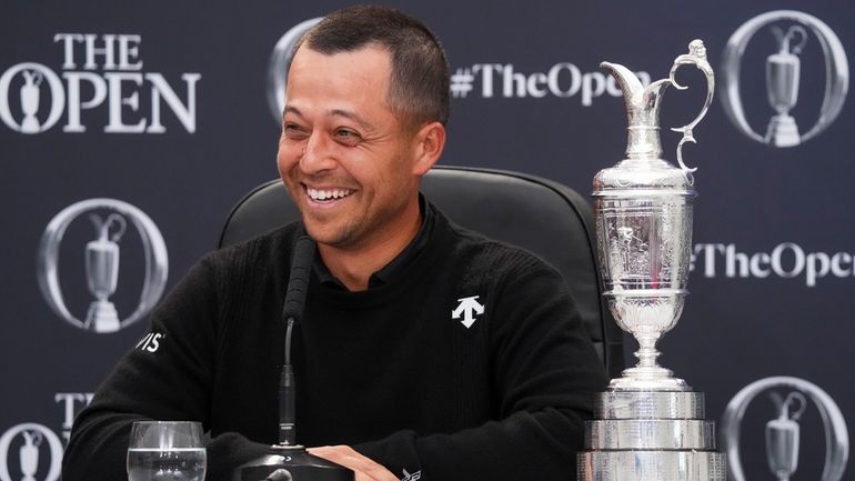 Xander Schauffele of the United States reacts as he sits...