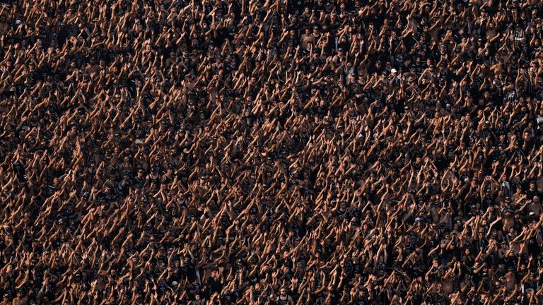 Corinthians fans cheer in the stands of the Neo Quimica...