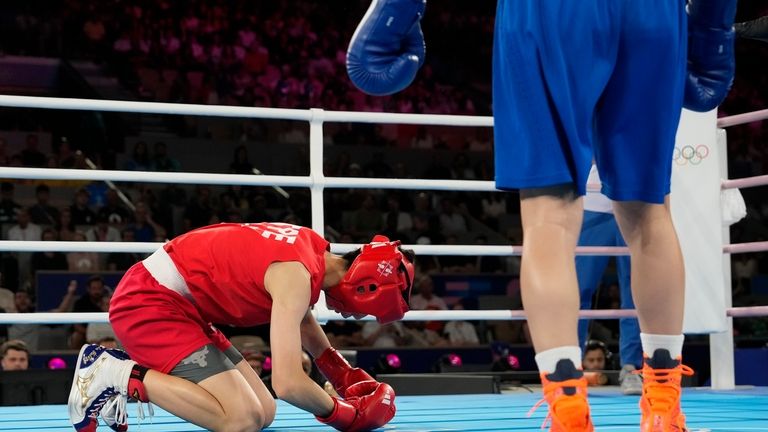 Taiwan's Lin Yu-ting, left, falls as she fights Turkey's Esra...