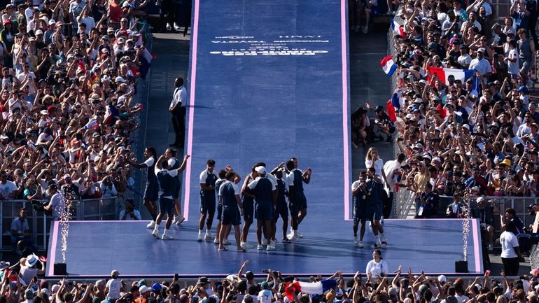 Athletes celebrate at the Champions Park, seen from the Eiffel...