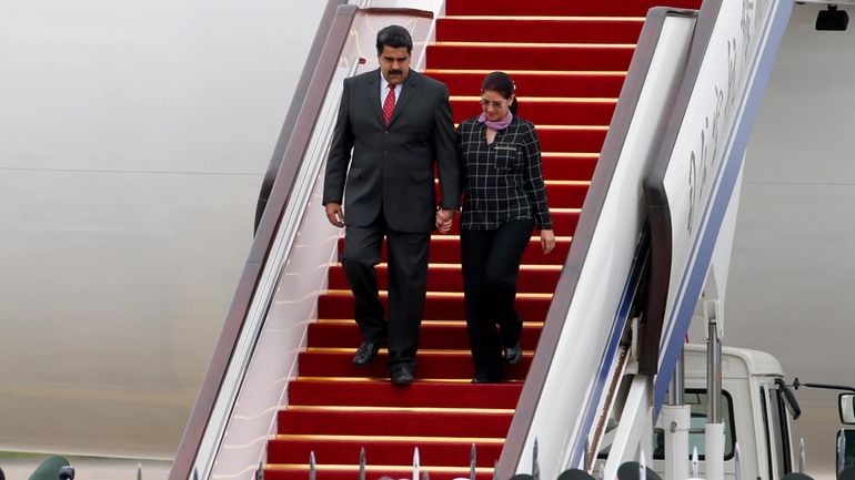 Venezuela's President Nicolas Maduro, left, and first lady Cilia Flores...