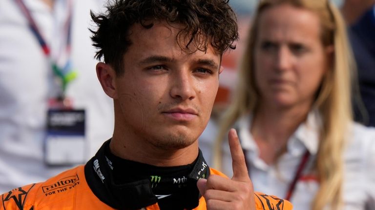 McLaren driver Lando Norris of Britain celebrates his pole position...