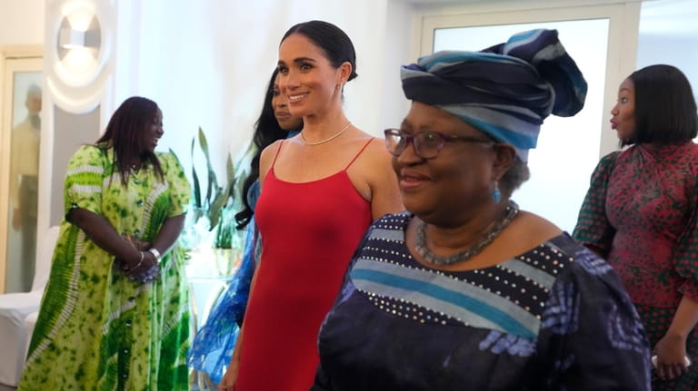 Meghan, the Duchess of Sussex, left, walks alongside Ngozi Okonjo-Iweala,...