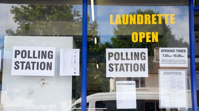 A polling station is installed inside a launderette for the...