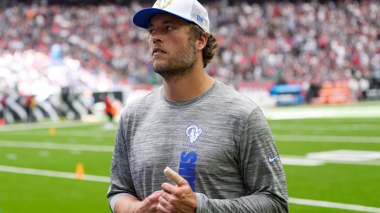 Los Angeles Rams quarterback Matthew Stafford walks off the field...