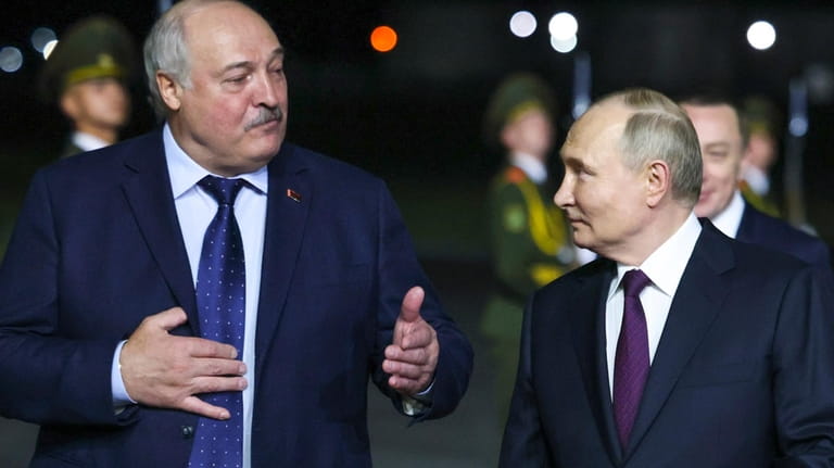 Russian President Vladimir Putin, right, listens to Belarusian President Alexander...