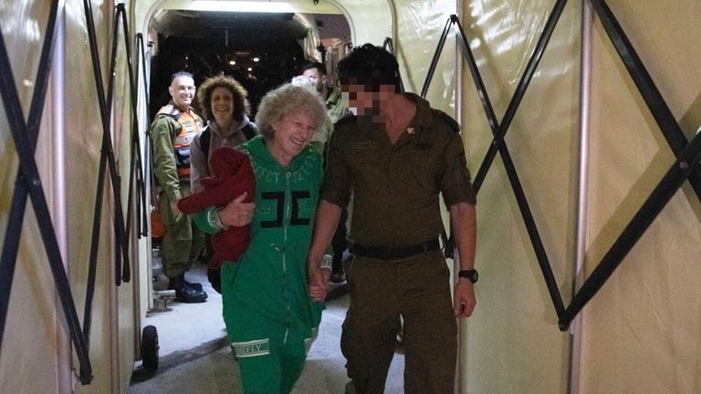 Ruth Munder, a released Israeli hostage, walks with an Israeli...