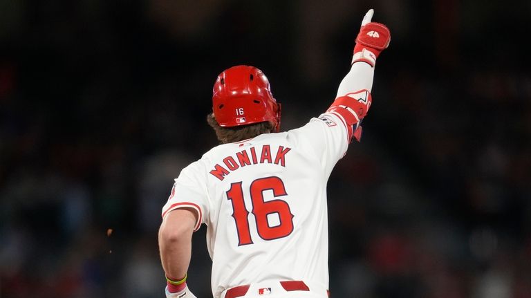 Los Angeles Angels' Mickey Moniak celebrates as he runs the...