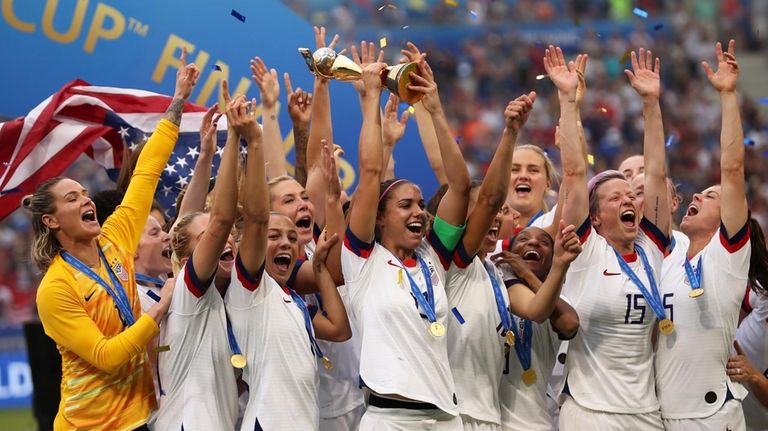 United States' Alex Morgan holds the trophy celebrating at the...