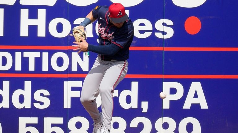 Atlanta Braves left fielder Jarred Kelenic fields a double by...