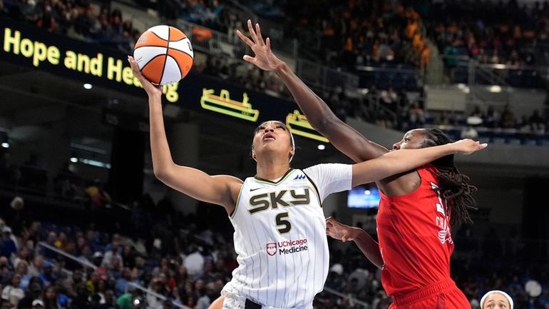 Chicago Sky's Angel Reese (5) shoots past the out stretch...