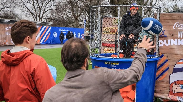 A dunk tank carnival game is filled with foam at...