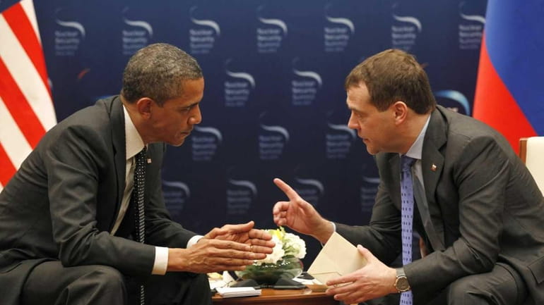 President Barack Obama, left, chats with Russian President Dmitry Medvedev...