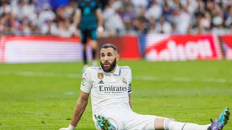 Real Madrid's Karim Benzema sits on the pitch during a...