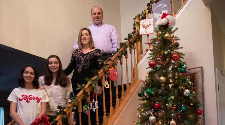 Liz Savitsky with her husband, Michael, and their two daughters,...