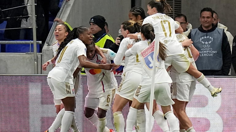 Lyon's Melchie Dumornay, 3rd left, celebrates after scoring her side's...