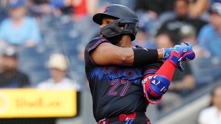 Toronto Blue Jays' Vladimir Guerrero Jr. hits an RBI single...