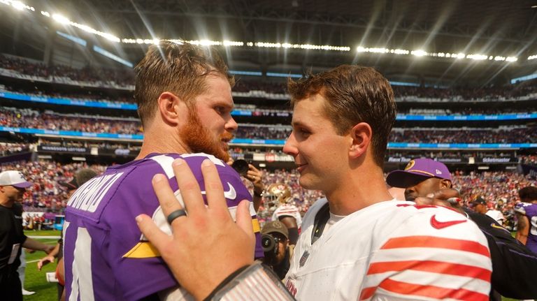 Minnesota Vikings quarterback Sam Darnold, left, talks with San Francisco...