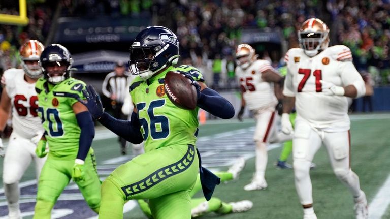 Seattle Seahawks linebacker Jordyn Brooks (56) returns a 12-yard interception...