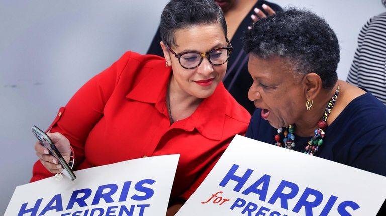 Supporters of Kamala Harris for President Kyle Alexandre, left, and...