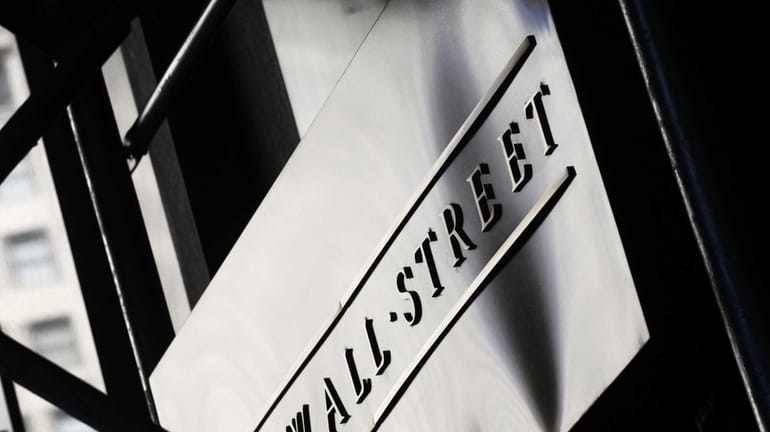A sign for Wall Street outside the New York Stock...