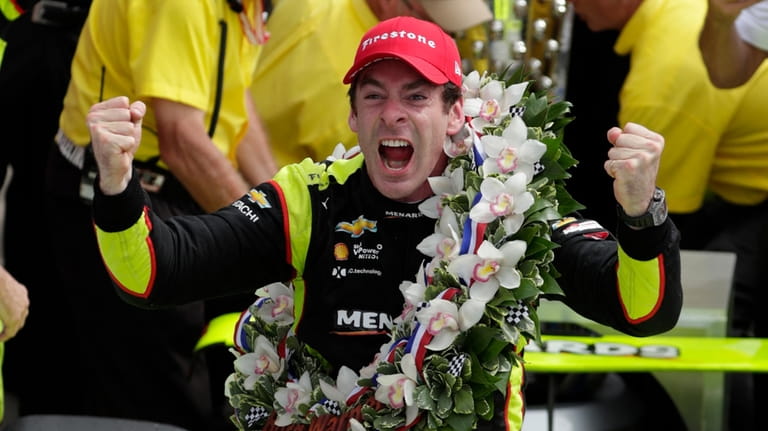 Simon Pagenaud celebrates after winning the Indianapolis 500 IndyCar auto...