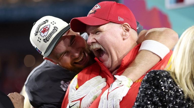 Travis Kelce and Kansas City head coach Andy Reid celebrate after defeating...