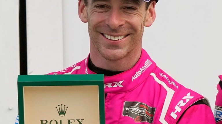 Simon Pagenaud shows off his Rolex watch in Victory Lane...