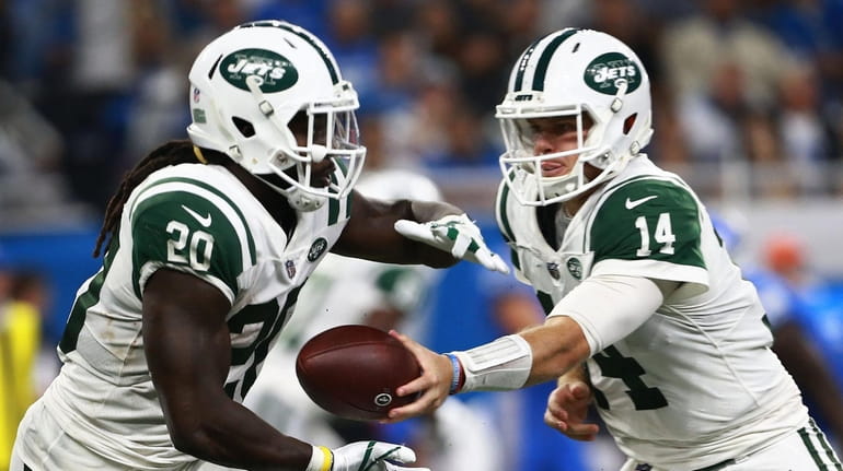 Sam Darnold #14 of the New York Jets hands the...