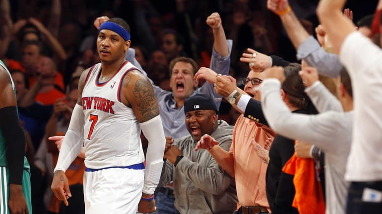 Fans celebrate after Carmelo Anthony hits a fourth-quarter basket against...