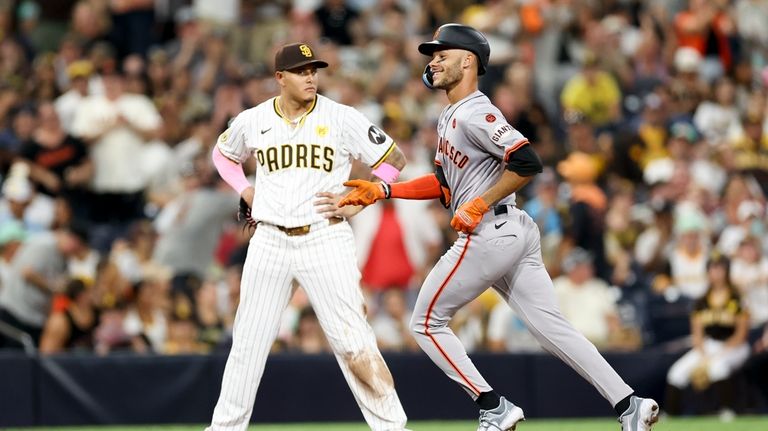 San Francisco Giants' Grant McCray, right, celebrates next to San...