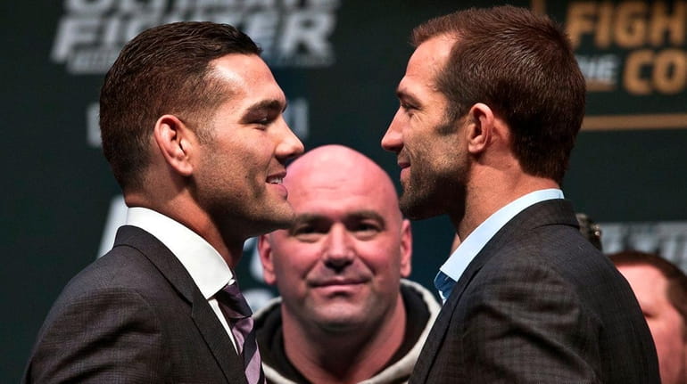 UFC Middleweight champion Chris Weidman, left, smiles at his opponent...