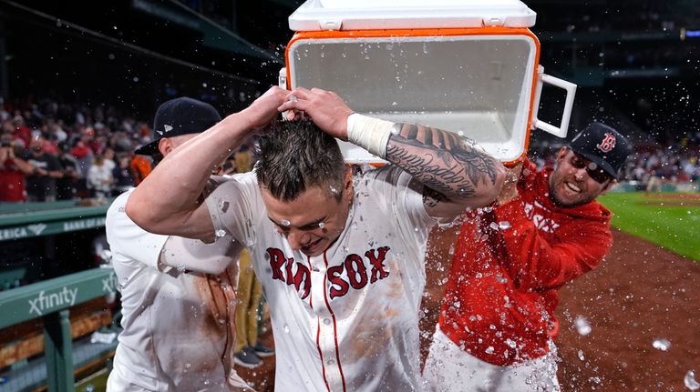 Boston Red Sox's Tyler O'Neill is doused with a cooler...