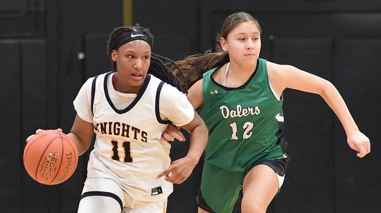 Darrian Jackson #11 of Uniondale, left, dribbles downcourt under pressure...