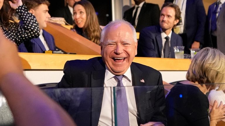 Democratic vice presidential nominee Minnesota Gov. Tim Walz laughs as...