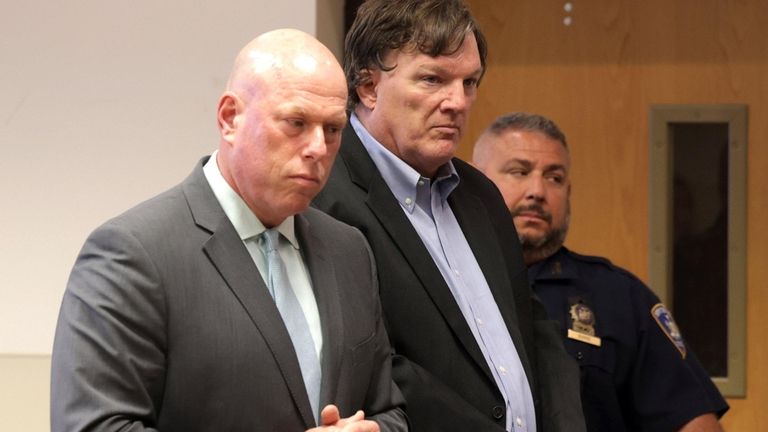 Accused Gilgo Beach killer Rex A. Heuermann, center, along with...