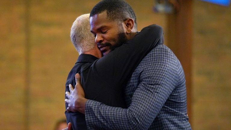 Carl Ruby, pastor at Central Christian Church, hugs Lindsay Aime...