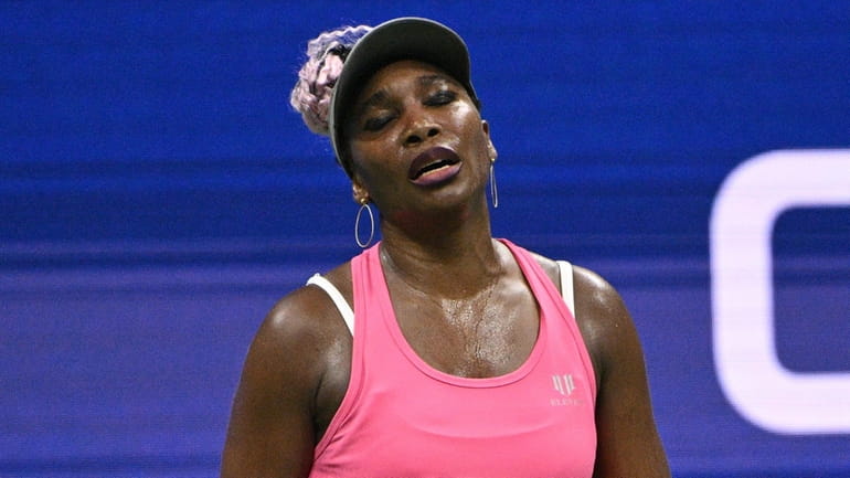 Venus Williams reacts during her match against Greet Minnen during...