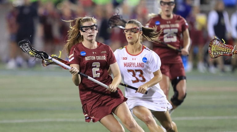 Boston College's Sam Apuzzo is pursued by Maryland's Kathy Rudkin...
