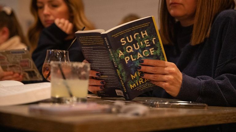 Krista Fehrenbach, of West Islip, reads a book at the...