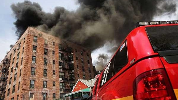 Firefighters battle a fire at a seven-story apartment building in...